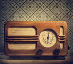 Antique radio on retro background